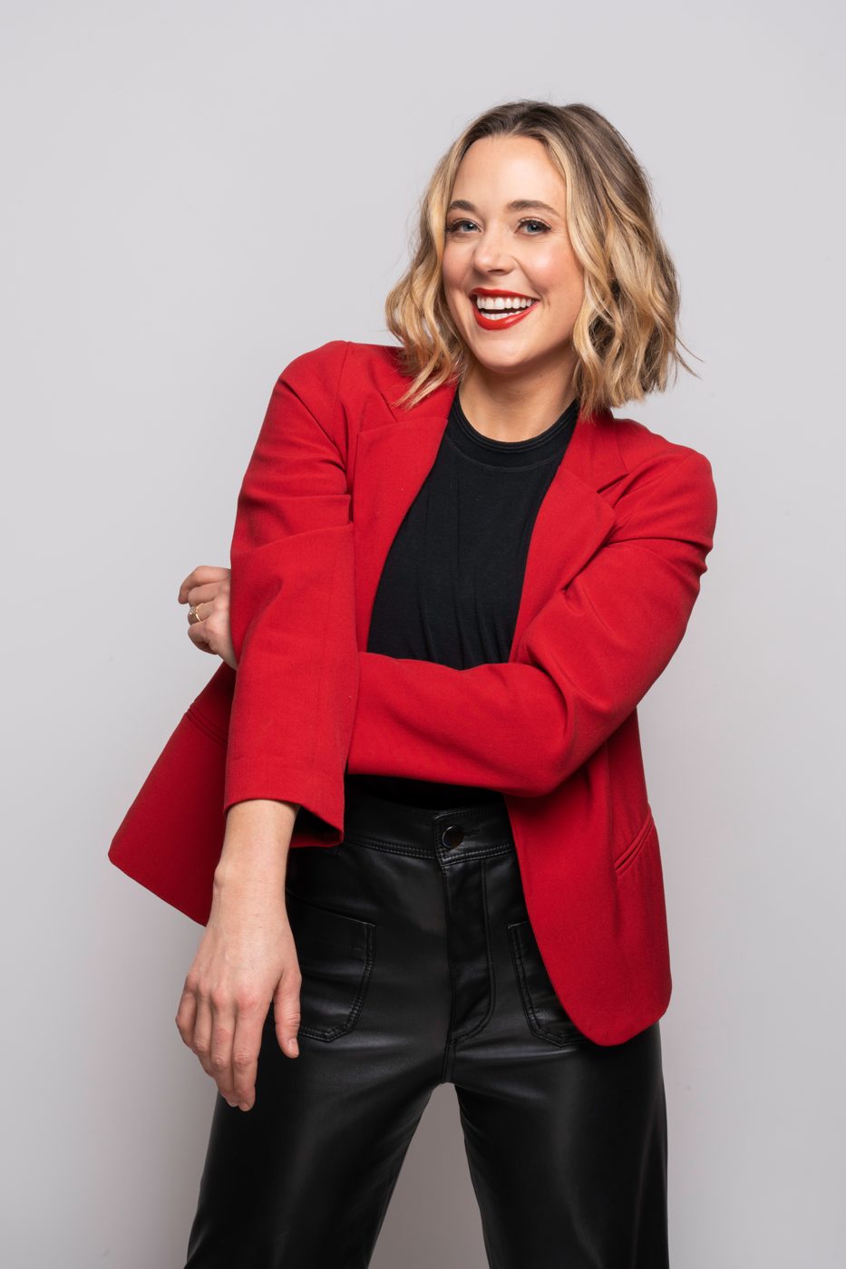 Smiling actor in a red blazer