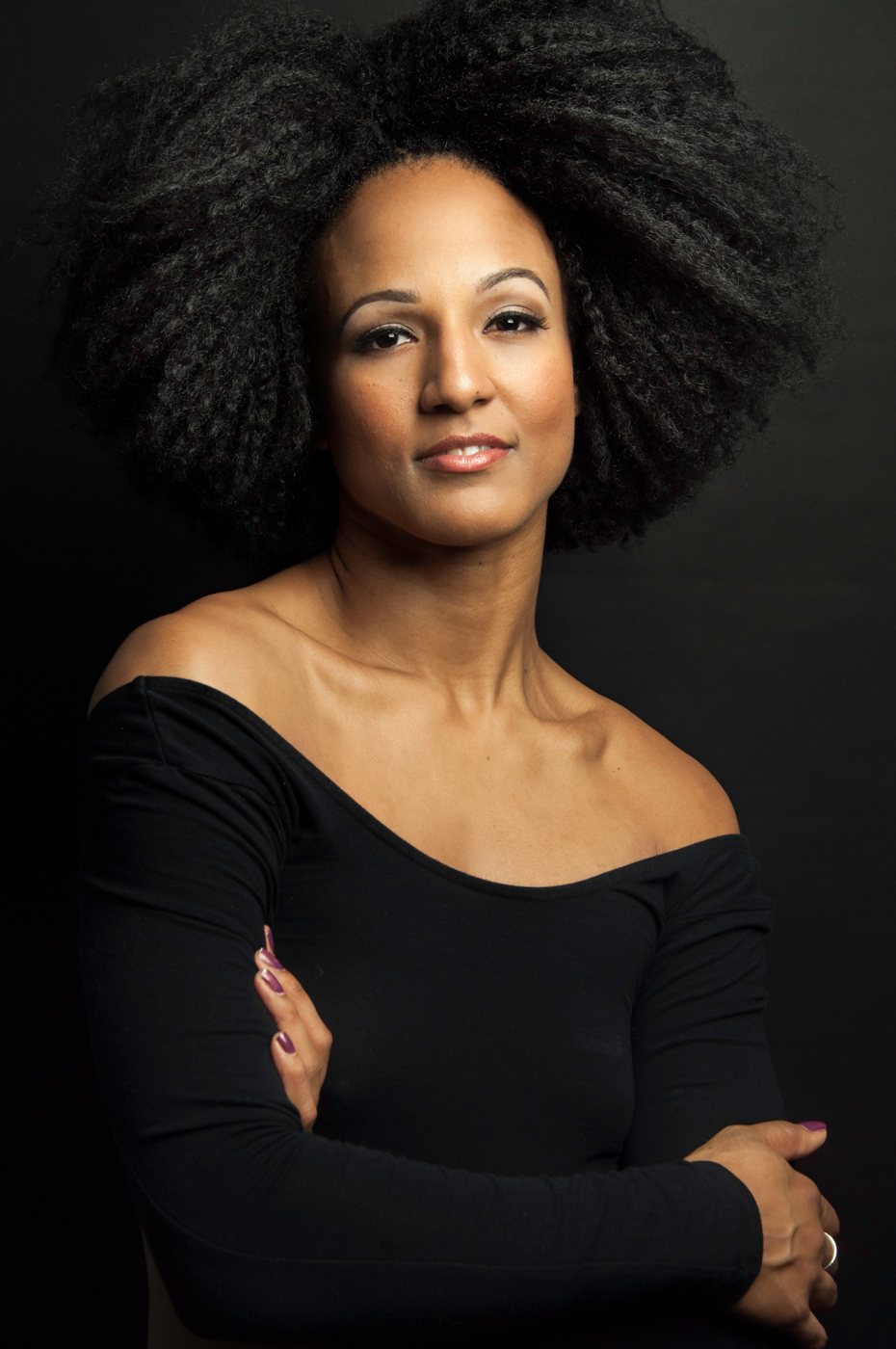 Portrait of a woman in a black off the shoulder top