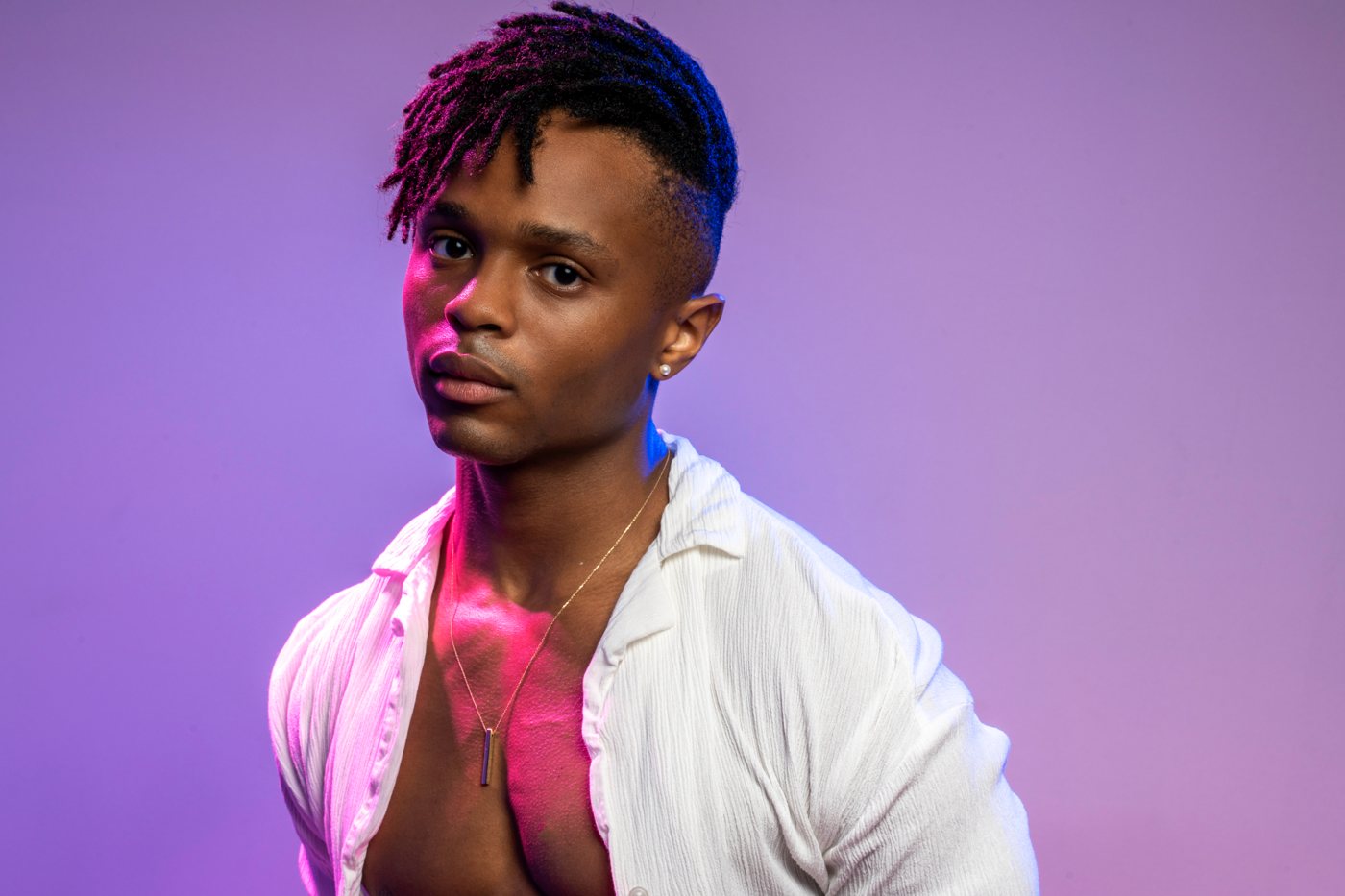 Portrait lit in purple and pink