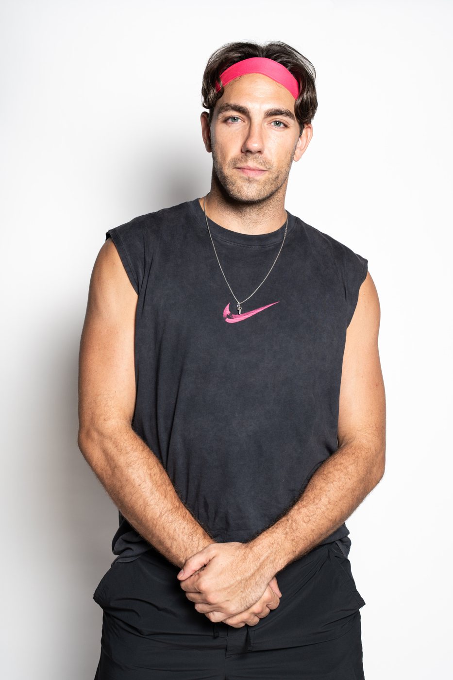 Portrait of an actor in a pink headband and sleeveless tee